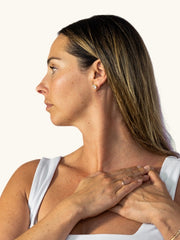 Ryan demonstrating The Neck Opener, hands resting at the collarbone